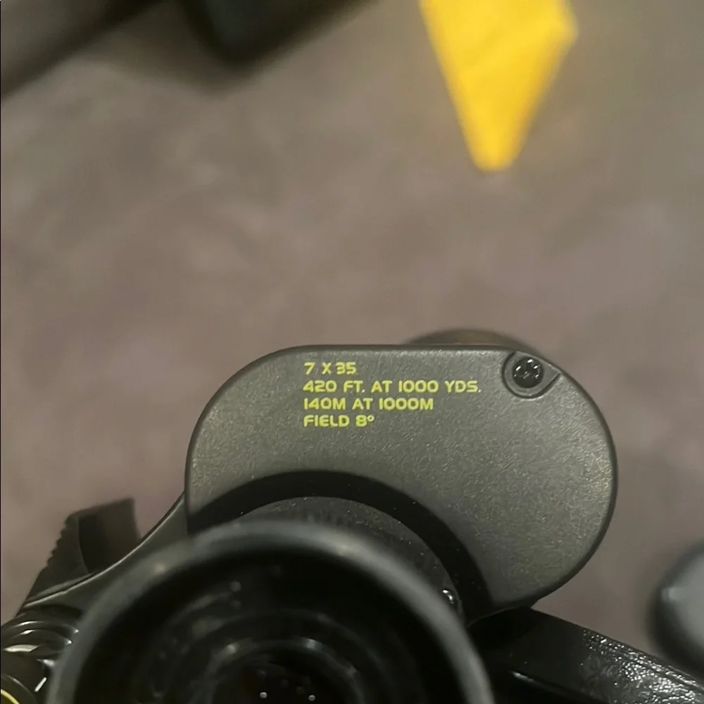 Black Bushnell Binoculars with Rubber Armor and Central Focus